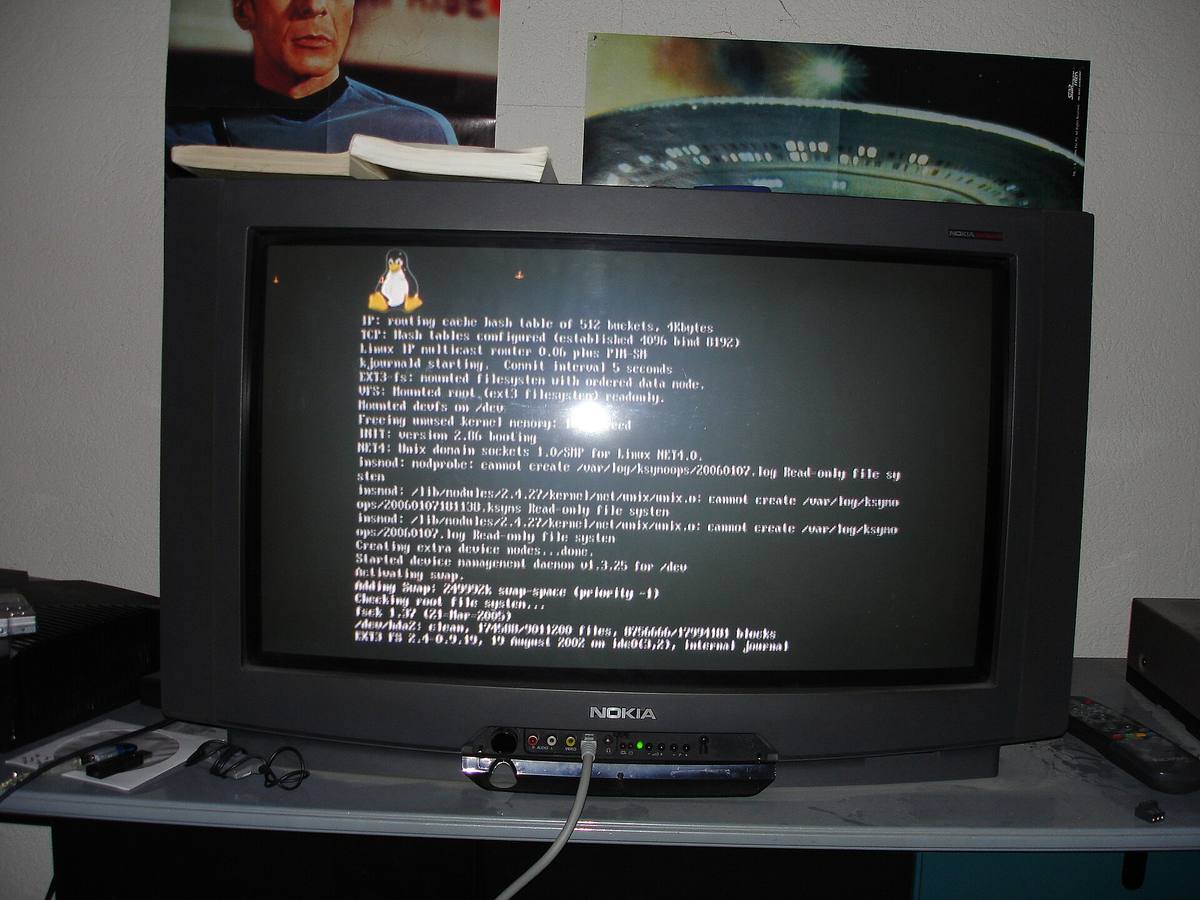 Televizor zobrazující startovní hlášky linuxového jádra